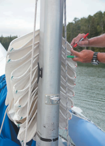 The colors left by permanent marker pens aren’t all that permanent: after a few years in the sun, they must be renewed. Keeping red marks to port and green ones to starboard means Mystic’s mainsail is folded the same way every time. After years of training, it practically folds itself when it’s dropped.