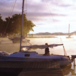 A picture of a boat in the sunrise