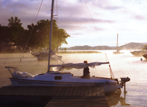 A picture of a boat in the sunrise