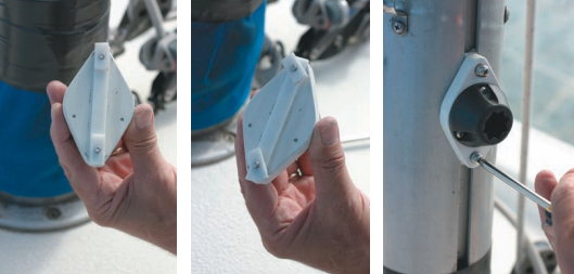 Line up the rectangular pieces of polycarbonate for installation. Turn the screws to angle them so the assembly locks in place on the mast, holding the winch handle.