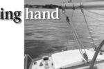 A bungee from boom to tiller steers the boat upwind under power.