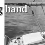 A bungee from boom to tiller steers the boat upwind under power.