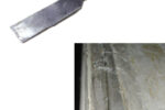A scraper or box knife would have a tough time cutting through this hardened and gritty toerail adhesive, below, but removing it with a heated chisel was a breeze.