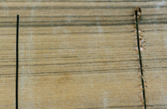 The damage to the teak veneer on the right-hand saw cut was caused by a conventional jigsaw blade cutting on the upstroke. The left-hand saw cut was made with an upside-down blade. In this case, the veneer was left intact.