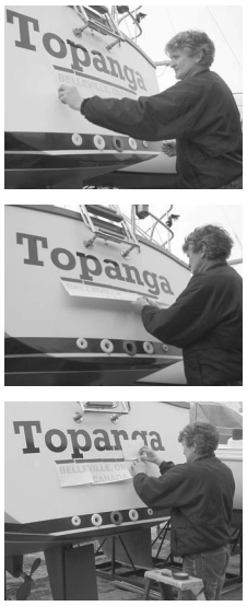 Belleville, Ontario, artist and graphics pro, Al Zaback, applies Topanga’s vinyl lettering for her port of call, above. Preparation of the hull is as important as centering and aligning the graphic prior to beginning the application process.