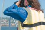 Picture of a woman using binoculars on a boat