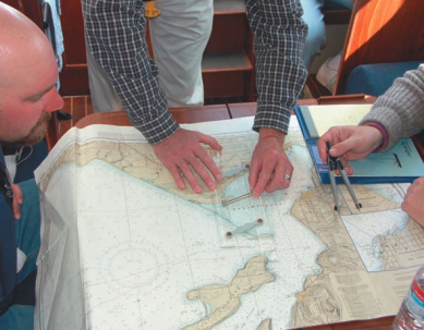The novice navigators determine where in the Apostle Islands they will take Jubilee during their practice cruise.