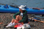 Picture of a woman sitting on a rock beach