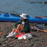 Picture of a woman sitting on a rock beach