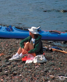 Picture of a woman sitting on a rock beach