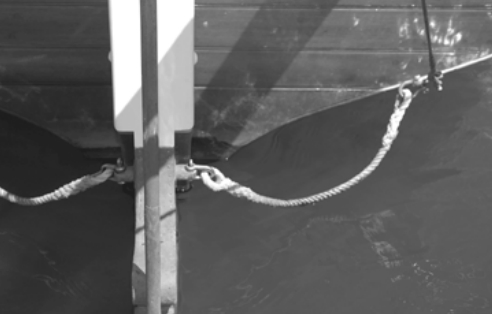 Taleisin’s rudder stops are spliced up from 7⁄16-inch prestretched Dacron lines. They run from eye-nuts on the outer edge of the rudder to the boomkin-stay chainplates, which are securely fastened through the hull of the boat.