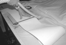 To compensate for the curvature of the sail, Gregg divided the length of the sail’s foot and leech by 4 and cut the insignia cloth into 8 panels plus 3 inches for overlap.