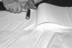 To ensure that there were no trapped air bubbles, he used a wallpaper seam roller to smooth the adhesive-backed cloth.