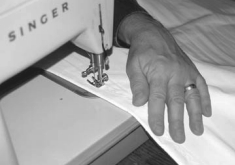 Using a zig zag stitch within 1⁄4 inch of the panel’s edge, he sewed the adhered panels to the sail with Dacron thread. This reinforced the panels.
