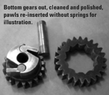 Bottom gears out, cleaned and polished, pawls re-inserted without springs for illustration.