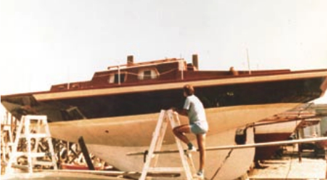 A younger Alex Tilley contemplates his project boat.