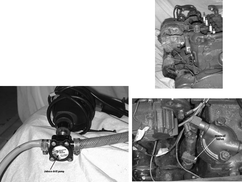 The Jabsco rotary pump, facing page, turns your power drill into a pumping device. Thermostat housing cover has been opened and thermostat has been removed, at right above. Note the manual valve on the Atomic 4 at right.