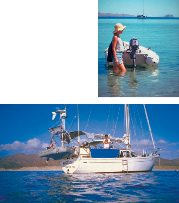 Above, Bette wades to the dinghy. In rocky areas, this cruising couple left the dinghy at anchor in shallow water near the beach. High tides at their return occasionally turned dinghy retrieval into a swim. At left, Maho Blues shows off the dinghy davits that bemused friends at the dock in the U.S. but were valuable in Baja.