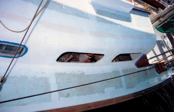 Primer has been applied. Some portlights have been removed; some are masked.