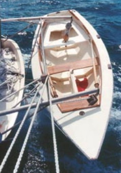 Gandy in the davits of my cold-molded wooden Virginia Pilot Schooner, Leopard. This photo shows Gandy Dancer’s final evolutionary form, with enclosed centerboard trunk, mahogany thwarts, sidedecks, foredeck, and coamings.
