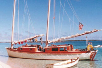 Teresa, Reuel’s cold-molded wood Exuma 44 cat schooner beached in the Bahamas. Note the stainless-steel-pipe stern davits for Gandy Dancer.