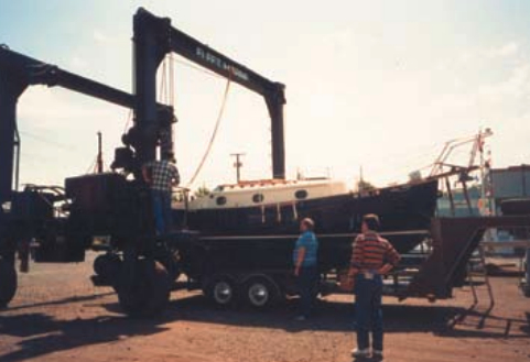 At left, Ron Chappell watches intently as his PS25, Raven, is transferred from her trailer.