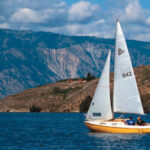 Rob Anderson leads the fleet at the mark, above. A San Juan 21 Mark II, on facing page, sails eastern Washington’s Lake Chelan with the Chelan Mountains as a backdrop.