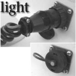 The closed cockpit receptacle by AMP, at right, and the receptacle in use. Advantages over the lowly cigarette lighter receptacle? At the top of the list are a twist-lock connection, so there are no surprises when unplugging, and a weather-resistant cap.