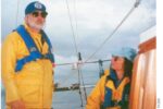 man and woman on a sailboat