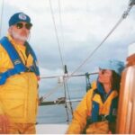 man and woman on a sailboat