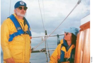 man and woman on a sailboat