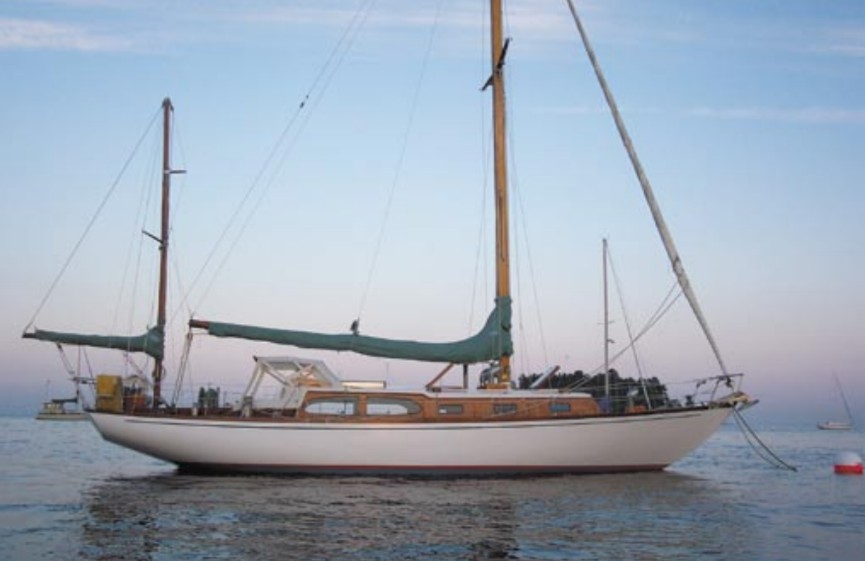 Christmas, a classic 38-foot 6-inch John Alden design built during the era of the CCA Rule, shows her overhanging stern and spoon bow to advantage in the fading light of a Maine sunset. One of the early fiberglass boats, she was one of approximately 50 Alden Challengers built in the 1960s.