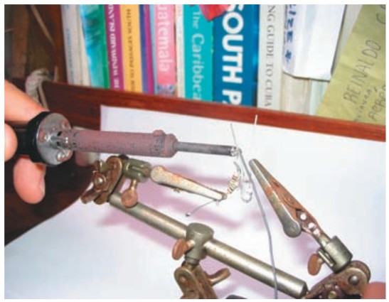 Use a small soldering iron to make connections. Be quick. Keep the iron in contact with the LED leads only long enough to make a connection. When possible, an alligator clip between the LEDs and the soldering point helps sink excess heat.