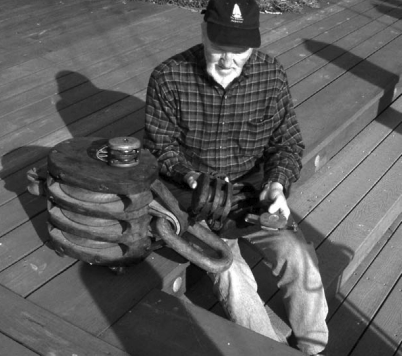 Who’s this gnome? We don’t mean to frighten you, but look what happened to Don Launer before he learned to give his wooden blocks regular maintenance. Actually, he says the large one, which weighs more than 90 pounds, was used to hoist cargo aboard a World War II Liberty Ship.