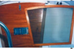 Frank Nowak created a 2⁄3 -sized hatch screen, at top, for his Hunter because a full-sized screen was difficult to stow. He made the screen frame from mahogany left over from making a new set of hatchboards, shown in center photos installed and as a pattern for the screen frame. A close-up view of the screen frame and screen attachment, bottom photo.