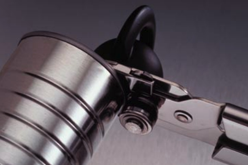 A good can opener is essential to the galley cook. One type leaves a smooth edge on the lid; conventional openers leave a smooth edge on the can.