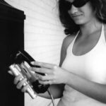 Amie Fort uses the family Pocketmail Composer to send email messages through a public phone.