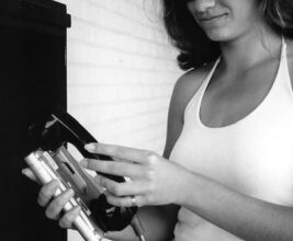 Amie Fort uses the family Pocketmail Composer to send email messages through a public phone.