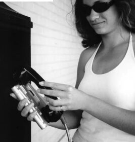 Amie Fort uses the family Pocketmail Composer to send email messages through a public phone.