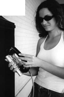 Amie Fort uses the family Pocketmail Composer to send email messages through a public phone.
