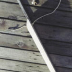 Fool a short dinghy into acting like a bigger boat by adding an extension to the aft end of the keel. The removable extension Paul developed attaches by inserting the tube at the top of this photo into a fixture he added to the keel of his Boatex dinghy. The line keeps the extension from being lost and sinking during the critical seconds it takes to attach it to the dinghy.