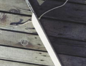 Fool a short dinghy into acting like a bigger boat by adding an extension to the aft end of the keel. The removable extension Paul developed attaches by inserting the tube at the top of this photo into a fixture he added to the keel of his Boatex dinghy. The line keeps the extension from being lost and sinking during the critical seconds it takes to attach it to the dinghy.