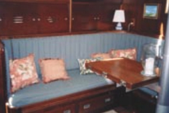 The vertical lines intensify this high-backed settee and create a feeling of height in the cabin.