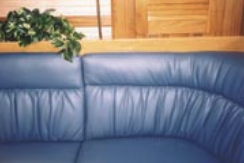 Complementary colors are used in this cabin with the orange hues of the teak cabinetry and the blue cushions. Remember to consider the wood in your boat when choosing a color for cushions.