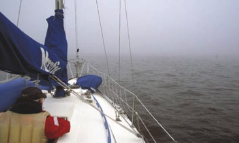 Jerry Powlas searches for the next marker as Mystic powers through the maze of buoys and Lake Superior fog near the twin ports of Duluth, Minnesota, and Superior, Wisconsin. All photos taken in early summer fog.