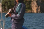Picture of someone with a camera on a boat