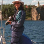 Picture of someone with a camera on a boat