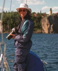Picture of someone with a camera on a boat