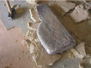 compactly as they had been placed the first time, Jim made plaster of Paris plugs, buried these in hard-packed sand, and poured molten lead in the cavities they left behind. One of these lead castings is shown, above right, free of the mold. He needn’t have worried about the space in his keel: the new ballast sits 2 inches lower than the original did.
