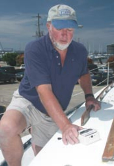 Bill Sandifer measures a deck on a boat under survey. Fortunately for the owner, the deck and hull proved to be dry with no problems.